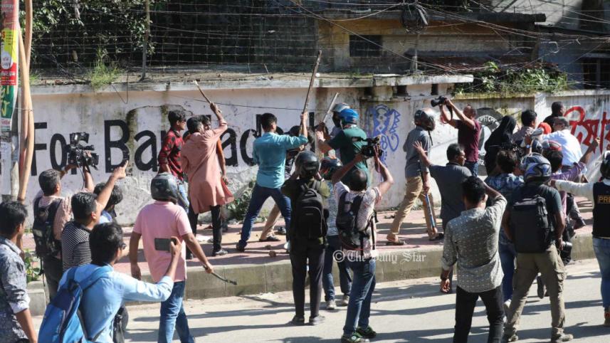 People carrying sticks during violence surrounding the quota-reform protests at Dhaka University on 15 July 2024.