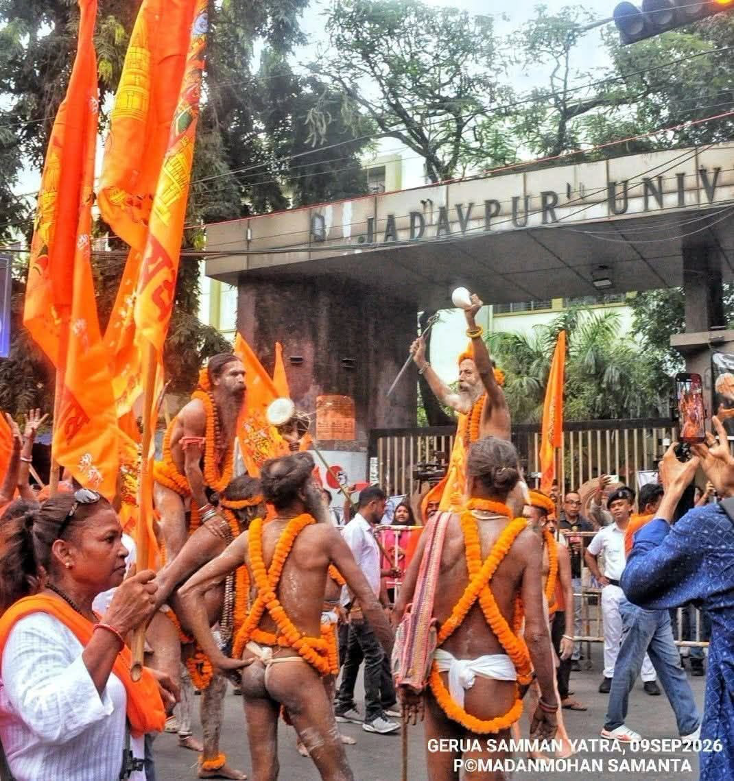 Participants carrying saffron flags during the Gerua Samman Yatra outside the entrance to Jadavpur University, Kolkata, 9 September 2026.